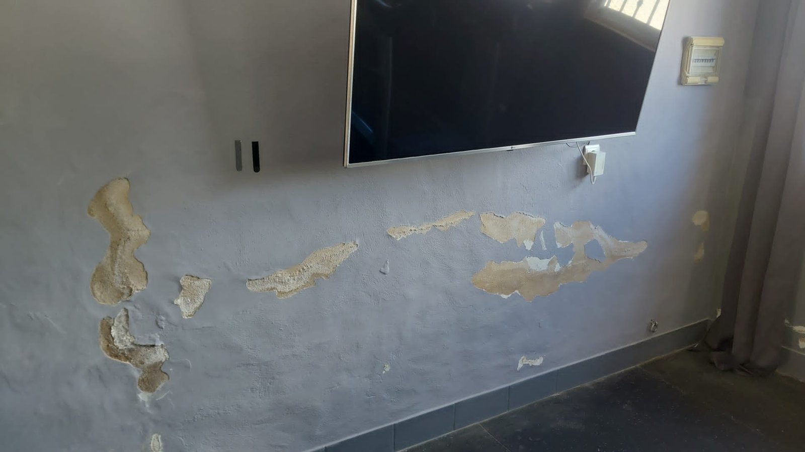 Wall prepared for relocation of electrical outlets beneath a television