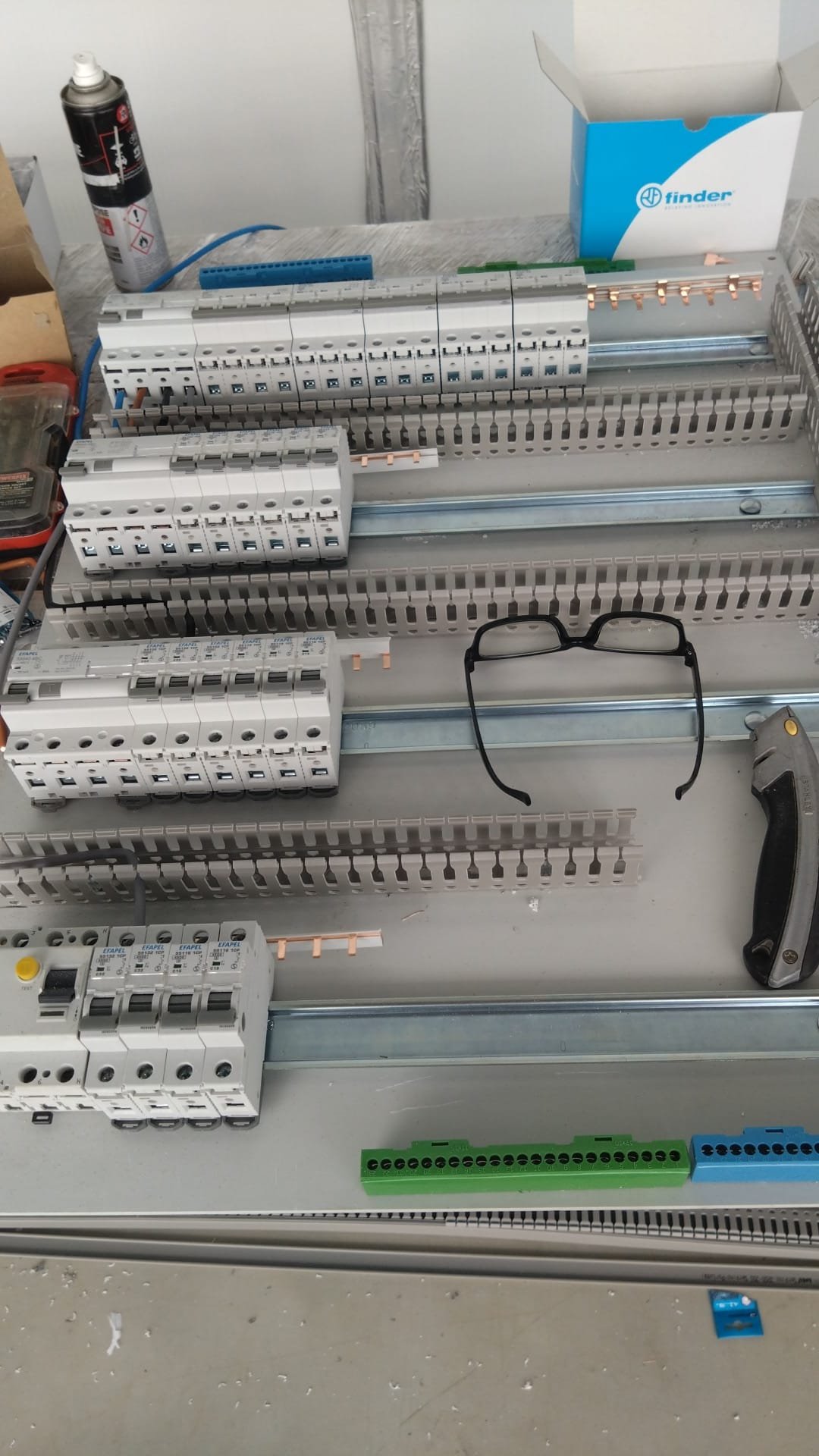 Breakers and RCD laid out on the mounting plate before the board is closed