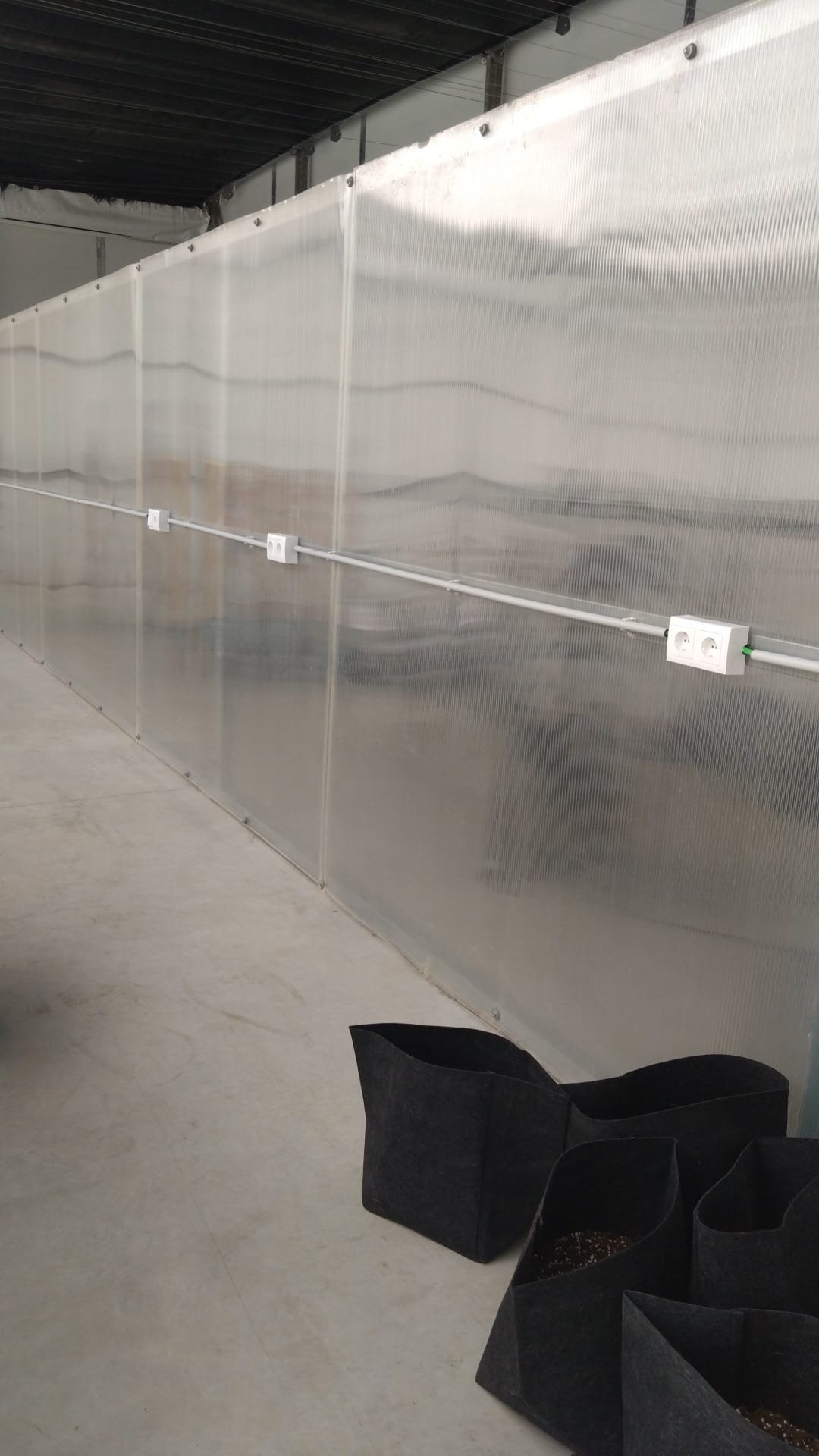 Sockets on surface conduit along a polycarbonate wall